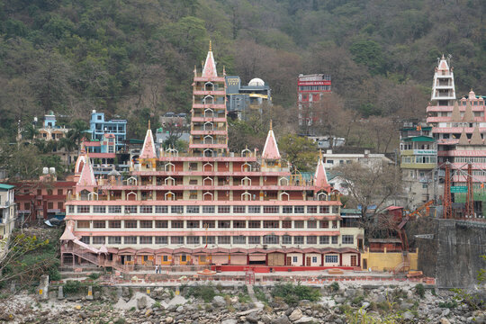 Rishikesh, India, March 2024. View of Ganges River, Lakshman Jhula bridge and Tera Manzil Temple, Rishikesh