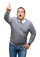 Fototapeta premium Middle age bussines arab man wearing glasses over isolated background Pointing with finger surprised ahead, open mouth amazed expression, something in front