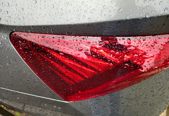 Tail light covered with rain drops.