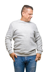 Middle age arab man wearing sport sweatshirt over isolated background looking away to side with smile on face, natural expression. Laughing confident.