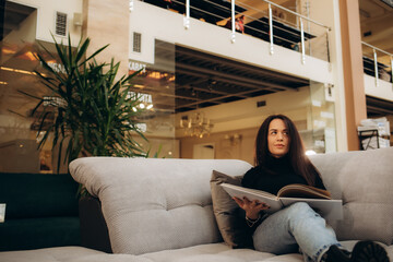 A woman looks through a catalog in a sofa store