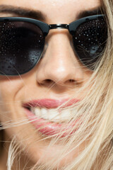Close-up portrait of a stylish young woman wearing sunglasses