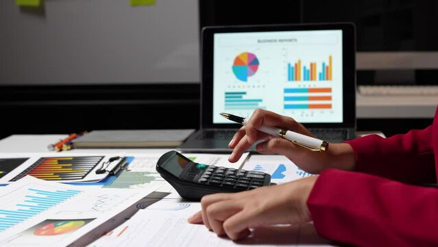 Asian businesswomen work using laptops and tablets, calculators to calculate make an account analysis report real estate investment information financial system concept and tax.