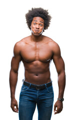 Fototapeta premium Afro american shirtless man showing nude body over isolated background puffing cheeks with funny face. Mouth inflated with air, crazy expression.
