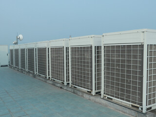 Industrial air conditioner condensers on the rooftop in a commercial building in Dhaka.