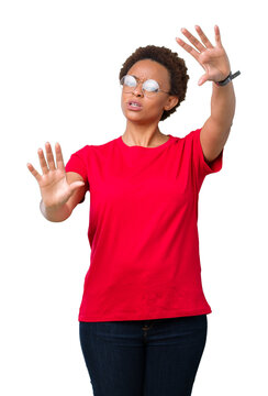 Beautiful young african american woman wearing glasses over isolated background Smiling doing frame using hands palms and fingers, camera perspective