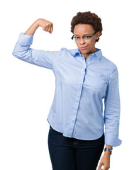 Young beautiful african american business woman over isolated background Strong person showing arm muscle, confident and proud of power