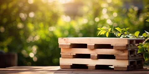 Stack of wooden pallets. The image has a natural and rustic feel, with a wooden palette and greenery all around