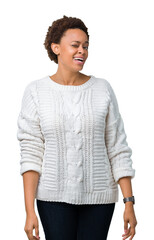 Beautiful young african american woman wearing sweater over isolated background winking looking at...
