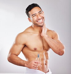 Happy, man and perfume in studio with skincare or grooming for self care, wellness and natural...
