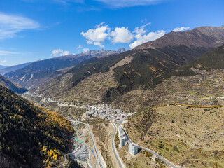 Bird's eye view from a drone on the Siguniangshan mountain. The leaves turn yellow during the beautiful autumn season in Changping Gou and Shuangqiao National Parks near Rilong Village, Chengdu, China