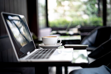 Laptop on table and coffee mug