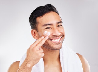 Face, portrait and asian man with moisturizer in studio for skin hydration, anti aging or collagen....