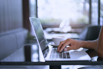 Young businessman's hands typing on laptop