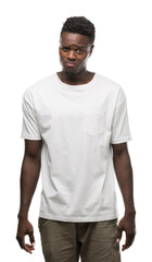 Fototapeta premium Young african american man wearing white t-shirt depressed and worry for distress, crying angry and afraid. Sad expression.