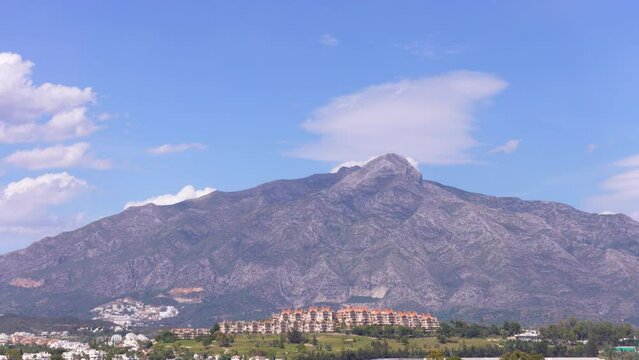 time lapse la concha mountain in spain marbella malaga on a sunny blue sky summer day, beautiful view of clouds a large mountain realestate