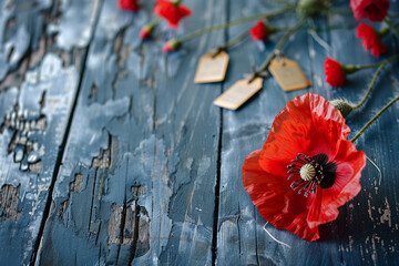 Obraz premium Distressed blue wood holds a red poppy and soldier's tags in a close-up Memorial Day scene.