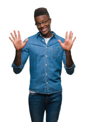 Fototapeta premium Young african american man over isolated background showing and pointing up with fingers number ten while smiling confident and happy.