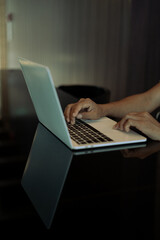 Young businessman's hands typing on laptop