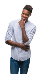 Fototapeta premium Young african american man over isolated background looking confident at the camera with smile with crossed arms and hand raised on chin. Thinking positive.