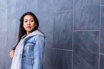 Obraz premium Young Asian woman in city serious face portrait