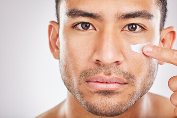 Asian man, portrait or face cream for beauty in studio with smile, natural cosmetics or glow for...