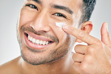 Happy Asian man, portrait or face cream for beauty in studio with smile, natural cosmetics or glow...