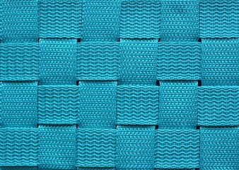 Turquoise square structured pattern cloth. The background of knitted artificial cloth material.