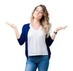 Beautiful young blonde woman over isolated background clueless and confused expression with arms...