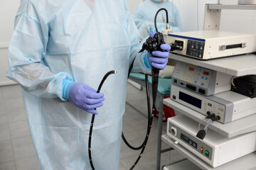 Instruments for diagnostic endoscopy close-up. The doctor holds a flexible endoscope in his hands. The process of gastroscopy, bronchoscopy or colonoscopy. Diagnostic and minimally invasive surgery.