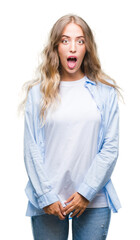 Beautiful young blonde woman over isolated background afraid and shocked with surprise expression, fear and excited face.