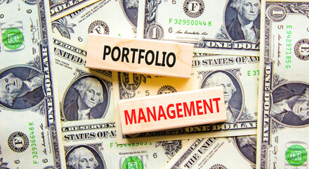 Portfolio management symbol. Concept words Portfolio management on beautiful wooden block. Beautiful dollar bills background. Dollar bills. Business Portfolio management concept. Copy space.