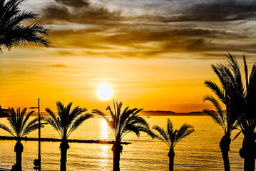 Beautiful sunset with orange sky on Aguadulce beach, Almeria, Andalucia	