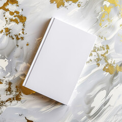 Mockup of a new book with blank white cover in modern neat style on an abstract white and gold paint background. Square template for social media post for books and advertisement.