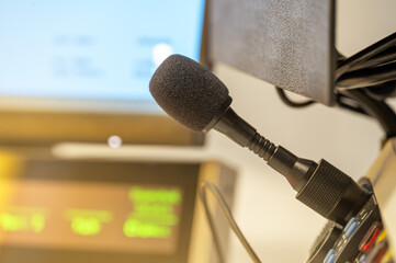 Close-up of microphone in broadcasting studio, blurred background equipment