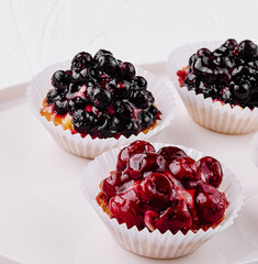 Assorted berry tartlets on white plate