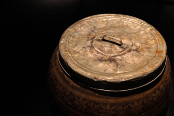 old jar lid on black background