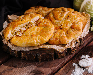 Rustic homemade cabbage pie on wooden table