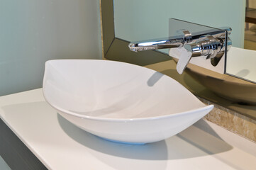 The modern washbasin and sleek faucet in the hotel bathroom combine style and functionality