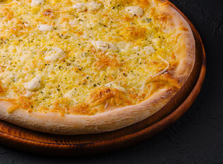 Fresh baked cheese pizza on wooden board