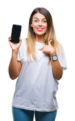 Fototapeta premium Young beautiful woman showing blank screen of smartphone over isolated background with surprise face pointing finger to himself