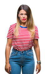 Young beautiful woman casual look over isolated background skeptic and nervous, frowning upset because of problem. Negative person.