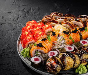 Assorted sushi platter on dark background