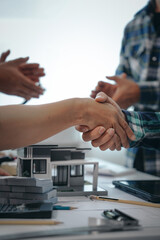 Engineers shaking hands, teamwork in meetings, drawing blueprints for condo, apartment, and house construction. Negotiating costs with contractors, bidding, and cooperating on construction sites.
