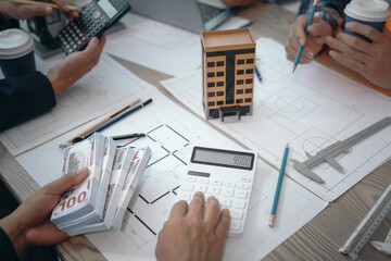 Skilled team of engineers collaborates in meetings, drafting blueprints for condos, apartments,...