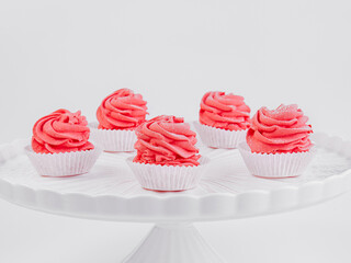 Red velvet cupcakes on white pedestal