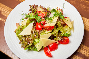 Salad with baked veal, tomatoes, cheese and herbs