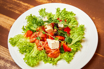 Salad with fresh vegetables, olives, Feta cheese and Balsamic pearls