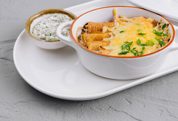 Baked cheesy pasta casserole with herbs