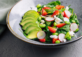 Fresh spinach avocado salad on stylish plate